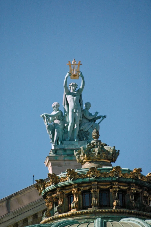 a statue that is on top of a building, palace of the chalice, singing at a opera house, square, brass