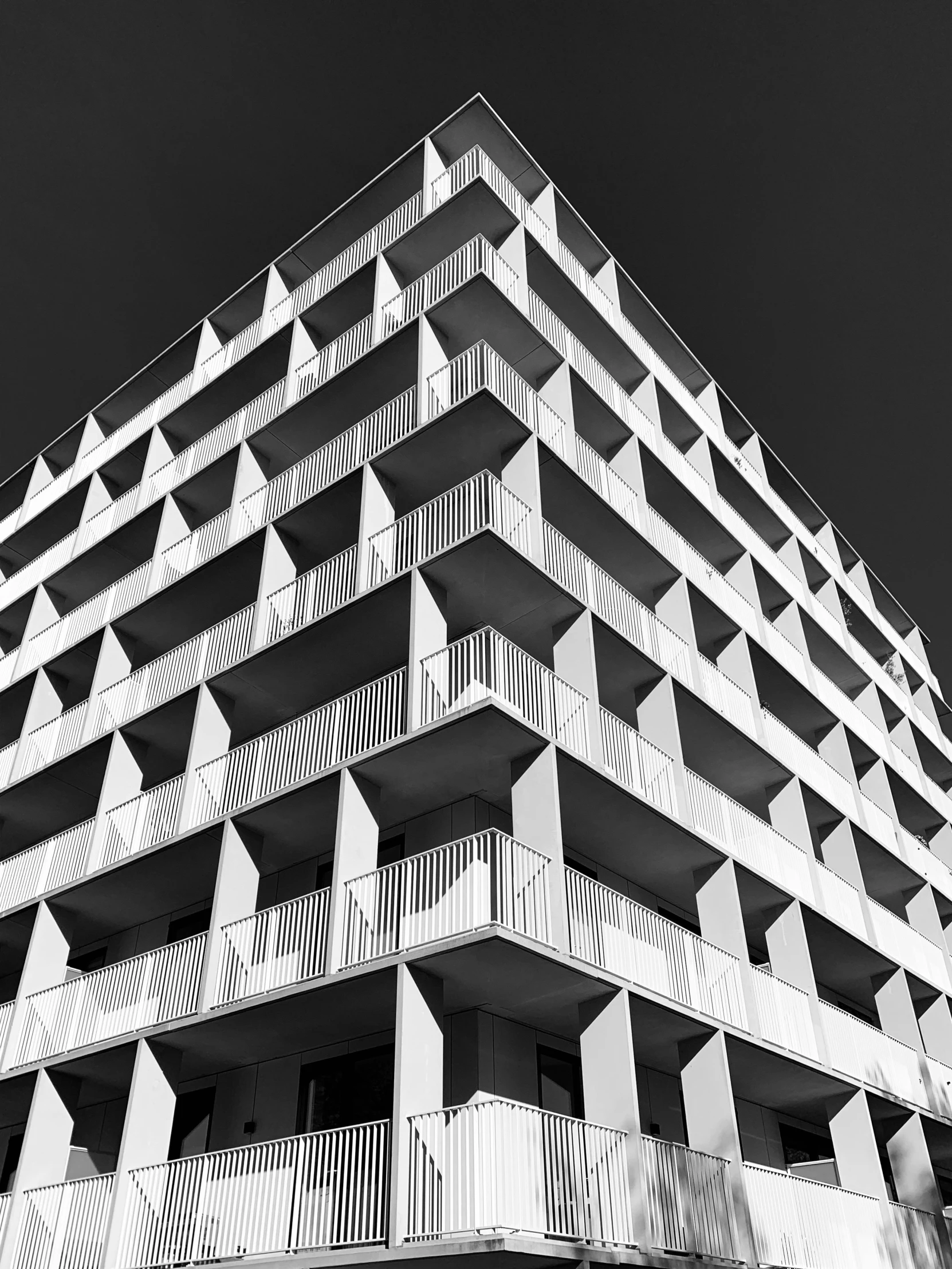 a black and white photo of a tall building, by Bauhaus, unsplash, brutalism, square, ilustration, monochrome hdr, crenellated balconies