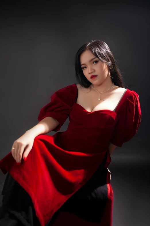 a woman in a red dress sitting on a chair, an album cover, inspired by Ruth Jên, instagram, renaissance, profile image, hana alisa omer, high quality photo, pouting