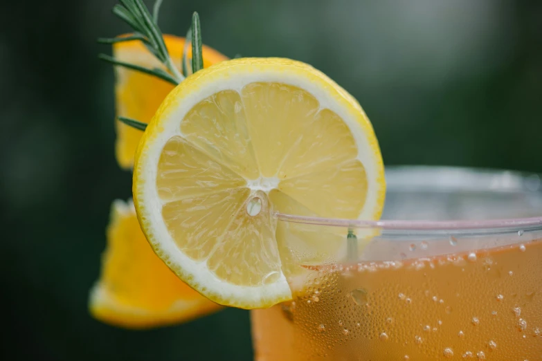 a close up of a drink with a slice of lemon, by Carey Morris, pexels, renaissance, light orange mist, thumbnail, manuka, various posed