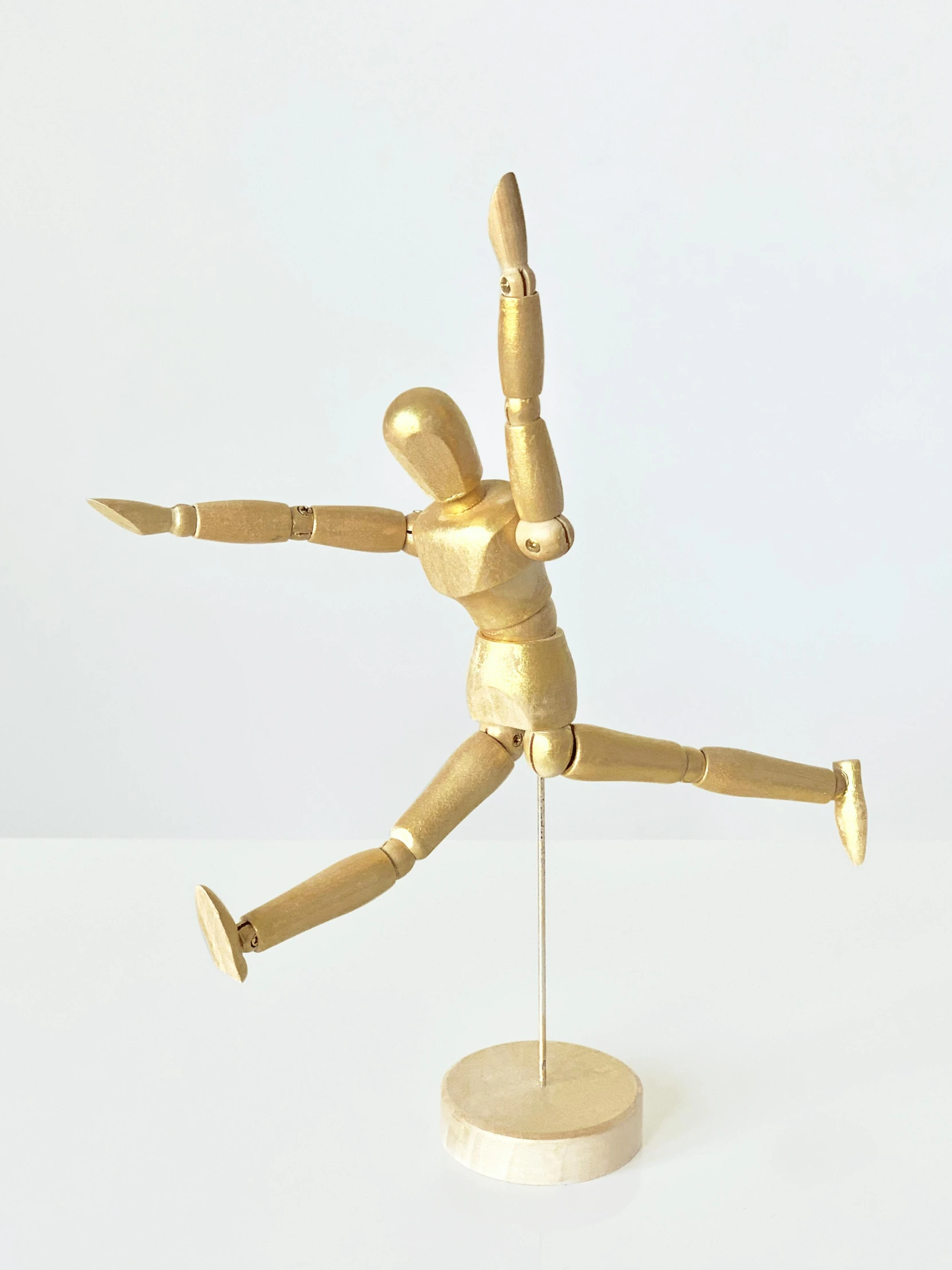 a wooden mannequin holding a tennis racquet, inspired by Graham Forsythe, kinetic art, gold foil, dynamic dancing pose, 2019 trending photo, made of gold