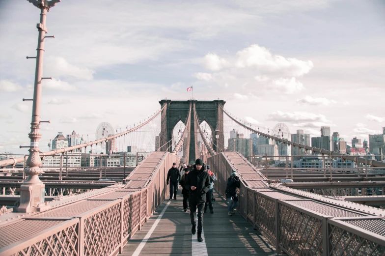 a group of people walking across a bridge, by Matija Jama, pexels contest winner, brooklyn background, 🚿🗝📝