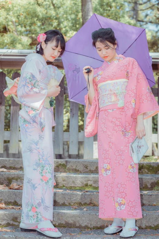 a couple of women standing next to each other holding umbrellas, by Sengai, pale pink and gold kimono, 🚿🗝📝, summer season, catalog photo
