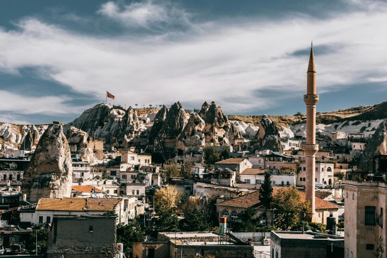 a view of a city with mountains in the background, a photo, turkey, tall stone spires, 1x, background image