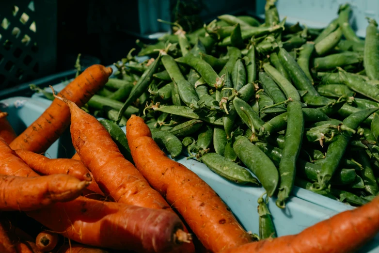 a pile of carrots and peas sitting next to each other, by Matt Cavotta, pexels, on a sunny day, avatar image, market, thumbnail