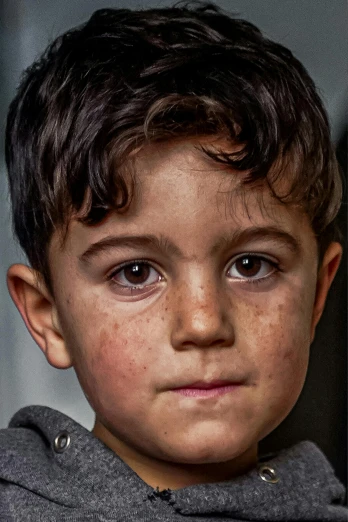 a close up of a child wearing a hoodie, a character portrait, pexels contest winner, hyperrealism, real life photo of a syrian man, perfect face and boy, weathered olive skin, 4yr old