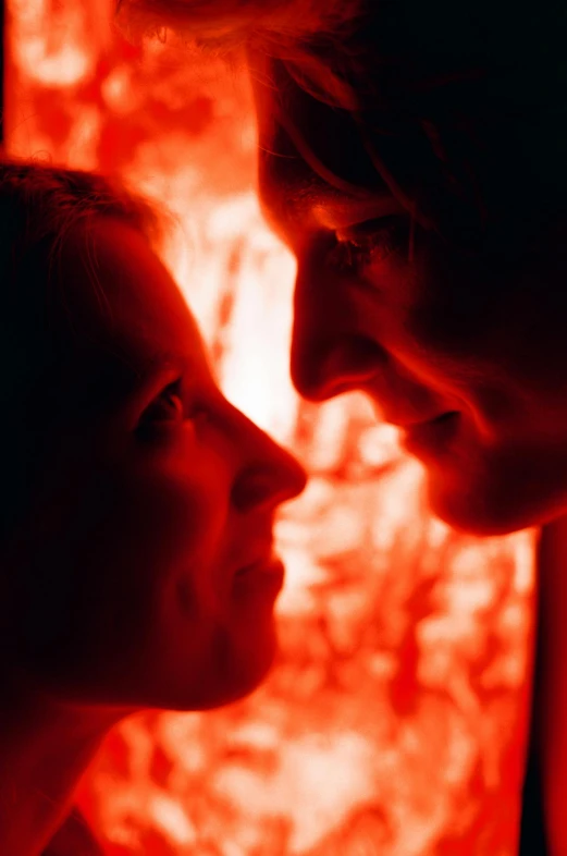 a man and a woman looking into each other's eyes, a picture, by Jan Rustem, glowing red, film promotional still, glowing inside, low-angle shot