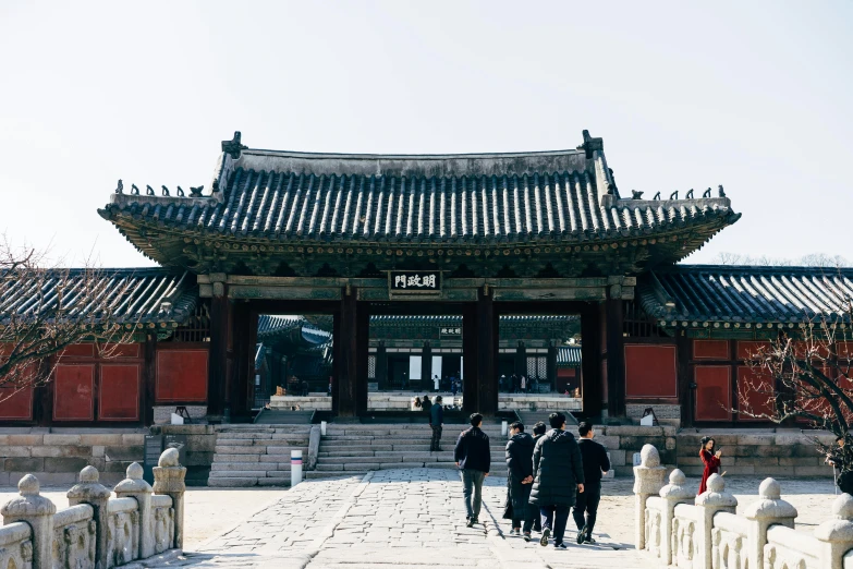 a group of people walking in front of a building, inspired by Shin Saimdang, trending on unsplash, the temple of truth is white, huge gate, royal palace interior, square