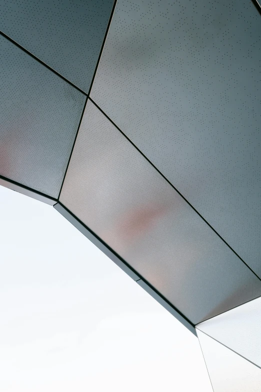 a close up of a building with a sky background, an abstract sculpture, by Doug Ohlson, unsplash, awnings, hexagonal wall, grey, arch