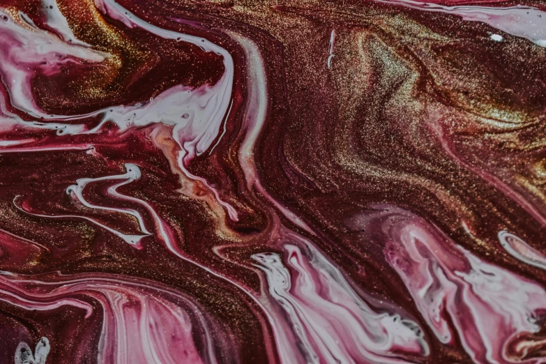 a close up of a liquid painting on a surface, by Sophie Pemberton, trending on pexels, maroon metallic accents, swirly, artist unknown, shades of pink