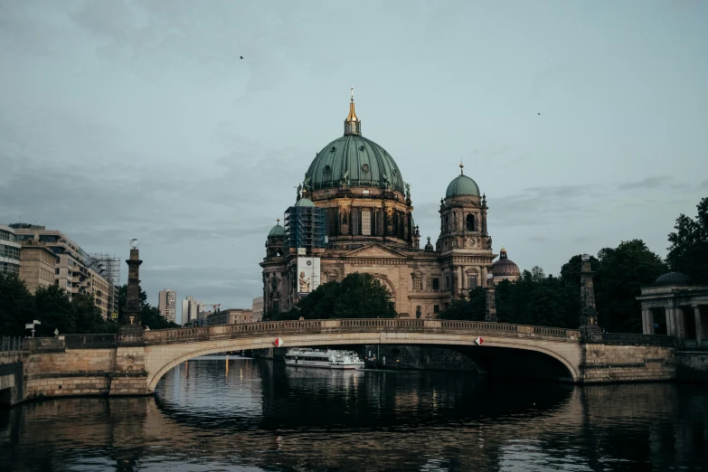 a bridge over a body of water with a building in the background, pexels contest winner, berlin secession, dome, 🦩🪐🐞👩🏻🦳, berkerk, conde nast traveler photo