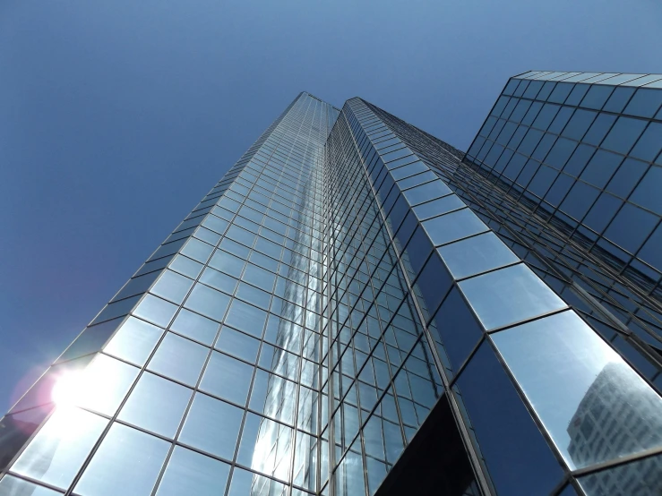 a couple of tall buildings that are next to each other, a picture, inspired by Richard Wilson, pexels contest winner, glass and metal : : peugot onyx, clear sky above, highly reflective surface, tungsten