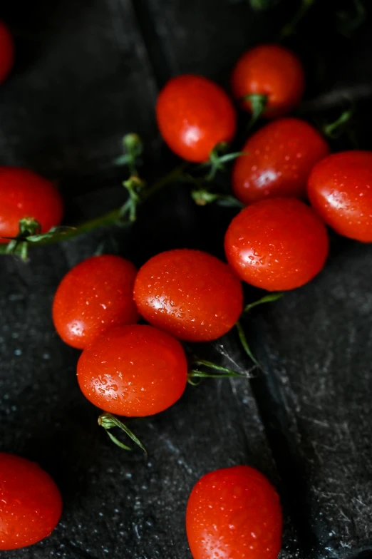 a bunch of tomatoes sitting on top of a wooden table, profile image