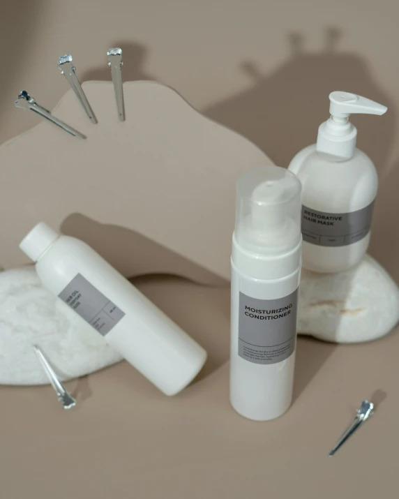 a couple of bottles of lotion sitting on top of a table, a portrait, inspired by Marina Abramović, unsplash, surgical supplies, white cloud hair, white mechanical details, product introduction photo