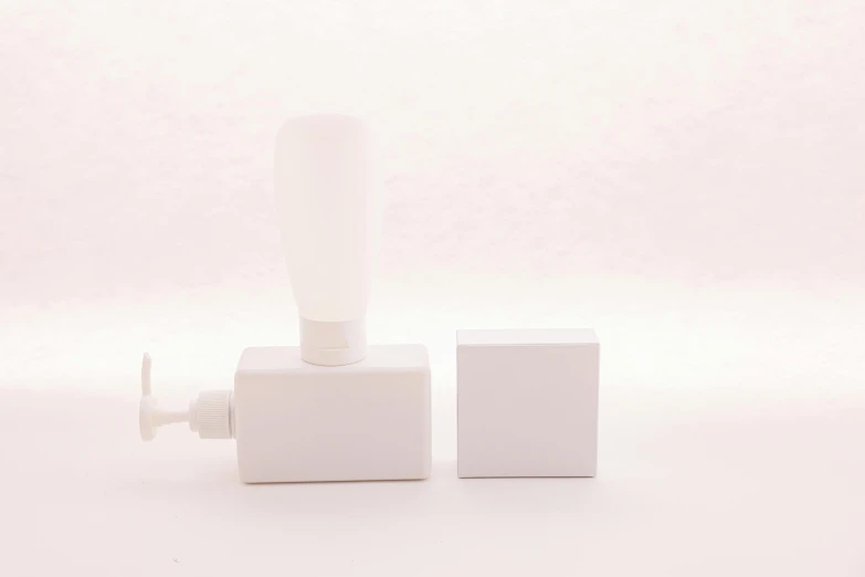 a couple of toothbrushes sitting on top of a white box, an ambient occlusion render, by Shigeru Aoki, unsplash, bauhaus, square facial structure, one single lamp, 1995, milk cubes