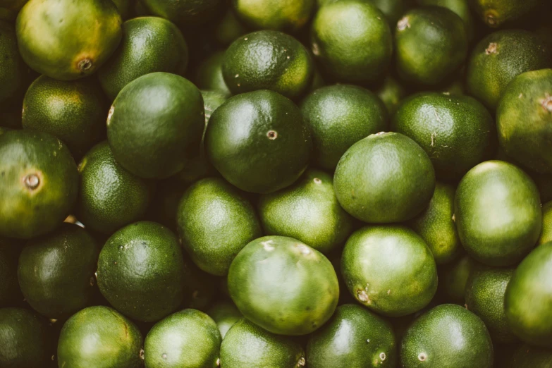 a pile of limes sitting on top of each other, by Emma Andijewska, trending on unsplash, green slime everywhere, 🦩🪐🐞👩🏻🦳, vintage color, thumbnail