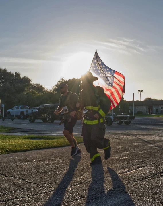 a man running with an american flag in his hand, a photo, firefighter, walking together, trending photo, slide show