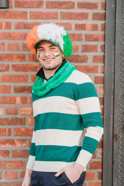 a man standing in front of a brick wall, inspired by Frank O'Meara, trending on reddit, wearing green clothing, rainbow stripe backdrop, 2 5 6 x 2 5 6 pixels, tom brady