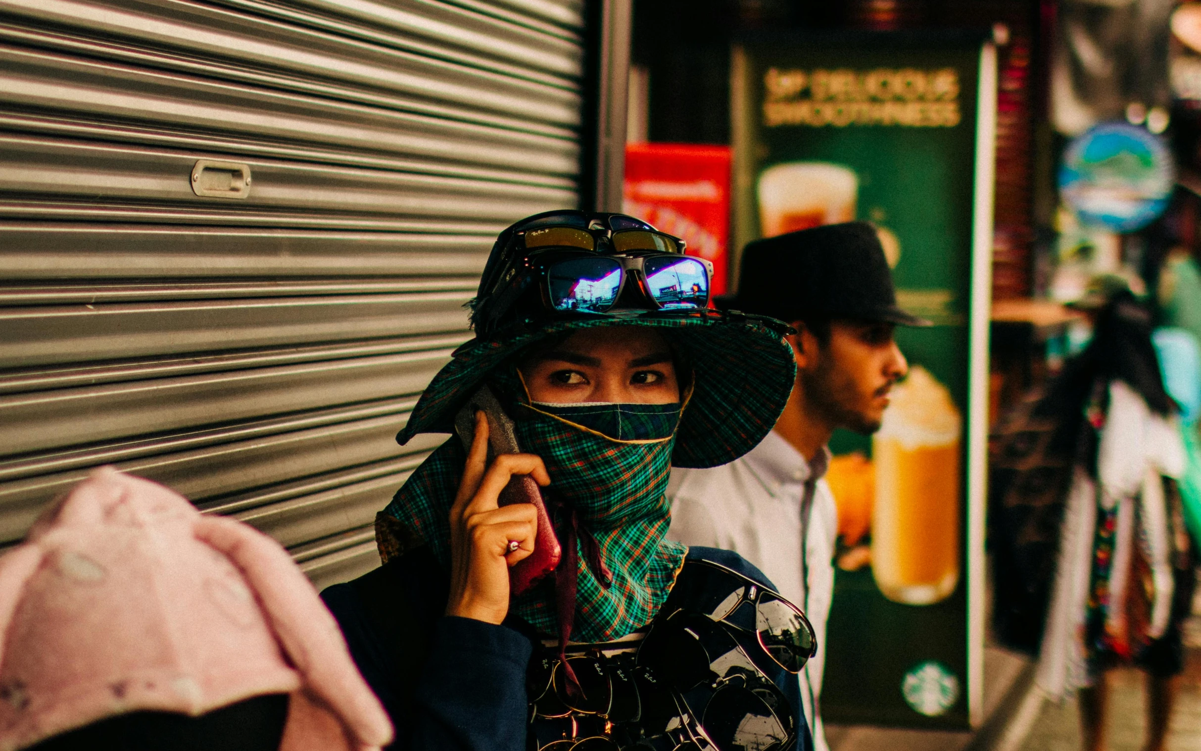 a woman walking down a street talking on a cell phone, a photo, inspired by Liam Wong, trending on unsplash, hyperrealism, bandanas, glowing eyes in helmet, mysterio, tekkon kinkreet