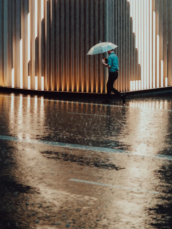 a person walking in the rain with an umbrella, inspired by Elsa Bleda, unsplash contest winner, wall of water either side, shiny reflective surfaces, promo image, contemplating