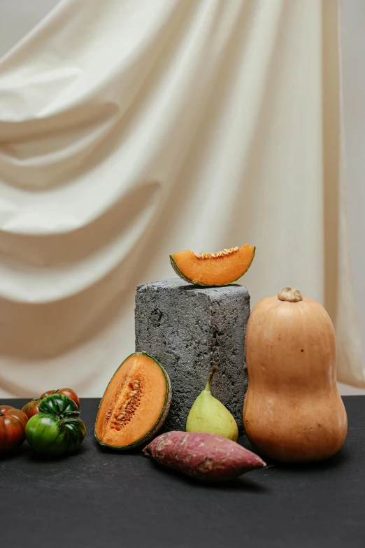 a table topped with different types of fruits and vegetables, a still life, inspired by Giorgio Morandi, unsplash, pumpkin, gray canvas, product shot, monument