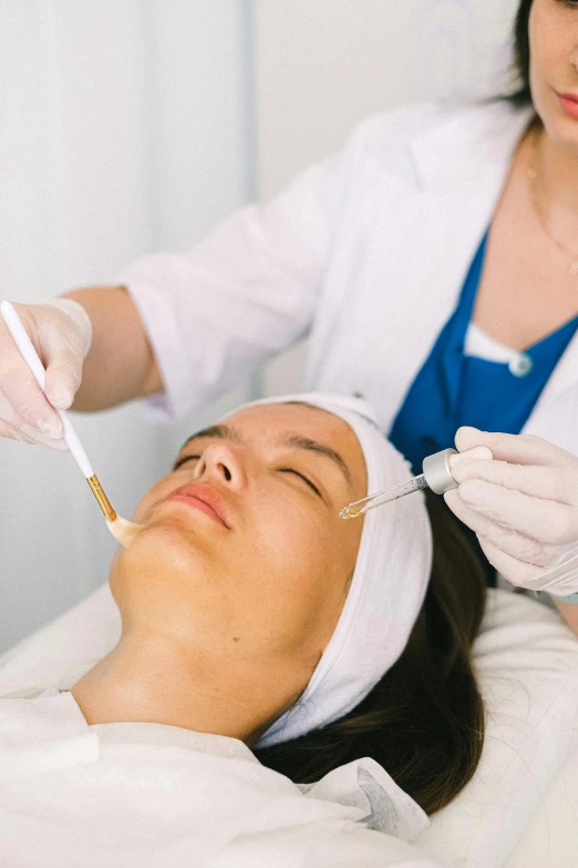 a woman getting an injection from a doctor, a digital rendering, trending on pexels, renaissance, her face is coated in a white, caramel, manuka, relaxed eyebrows