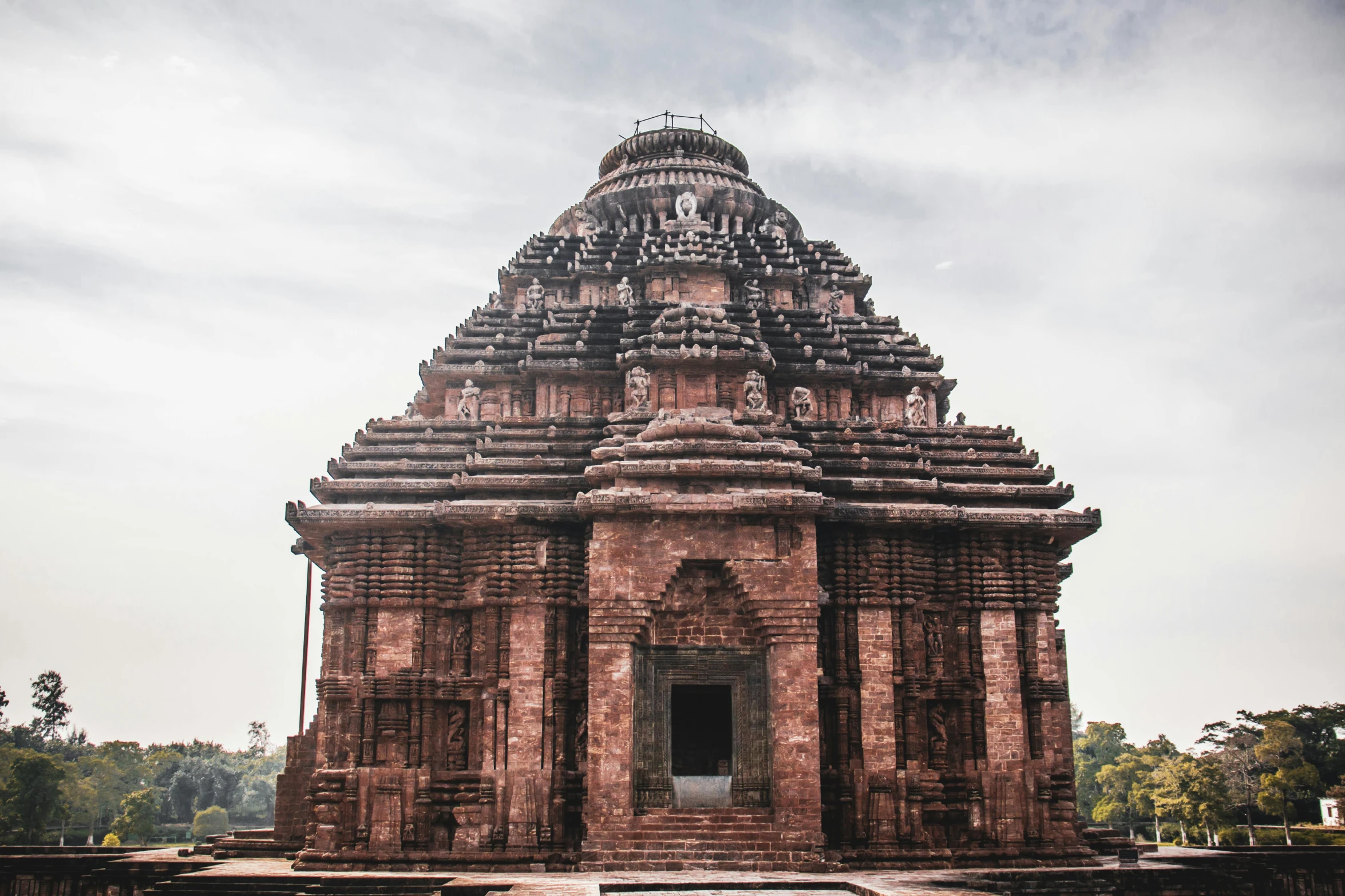 a large brick structure sitting in the middle of a park, an album cover, inspired by Ram Chandra Shukla, pexels contest winner, renaissance, epic khajuraho, exterior of scifi temple, profile image, kalighat