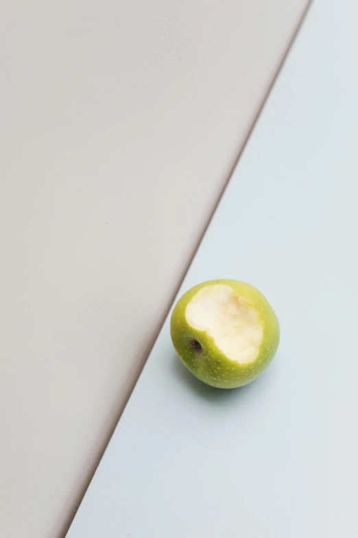 a green apple sitting on top of a cutting board, by Harvey Quaytman, square, cream, 10k, portrait of small