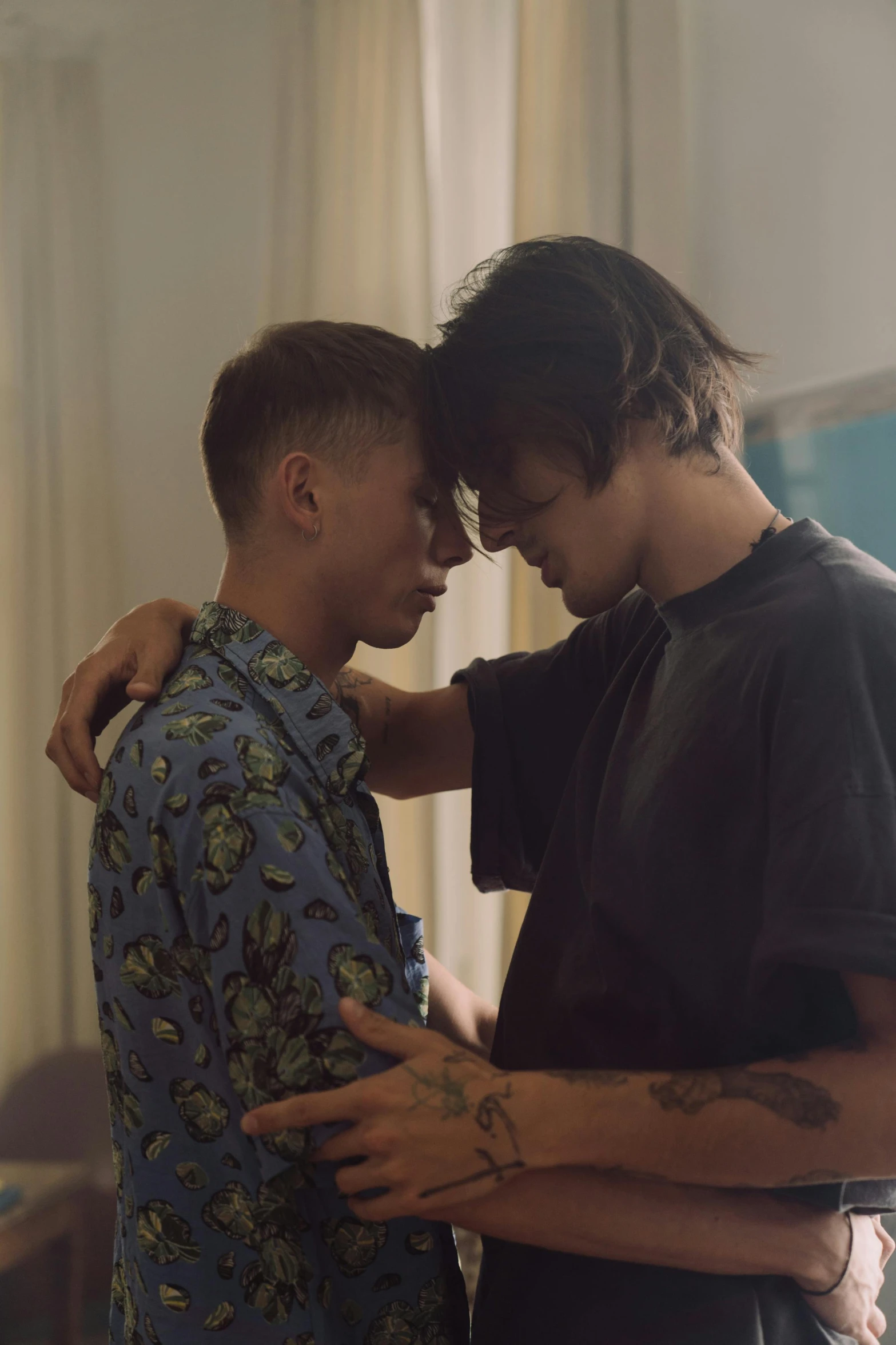a couple of men standing next to each other, trending on tumblr, symbolism, lesbian embrace, still from a music video, undercut, comforting and familiar