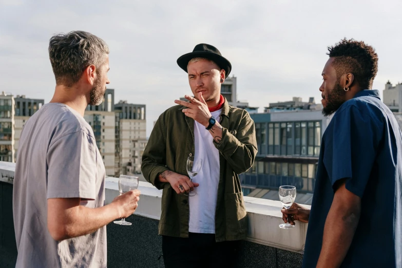 a group of men standing on top of a roof, pexels contest winner, holding a drink, jordan grimmer and james jean, lachlan bailey, eating outside