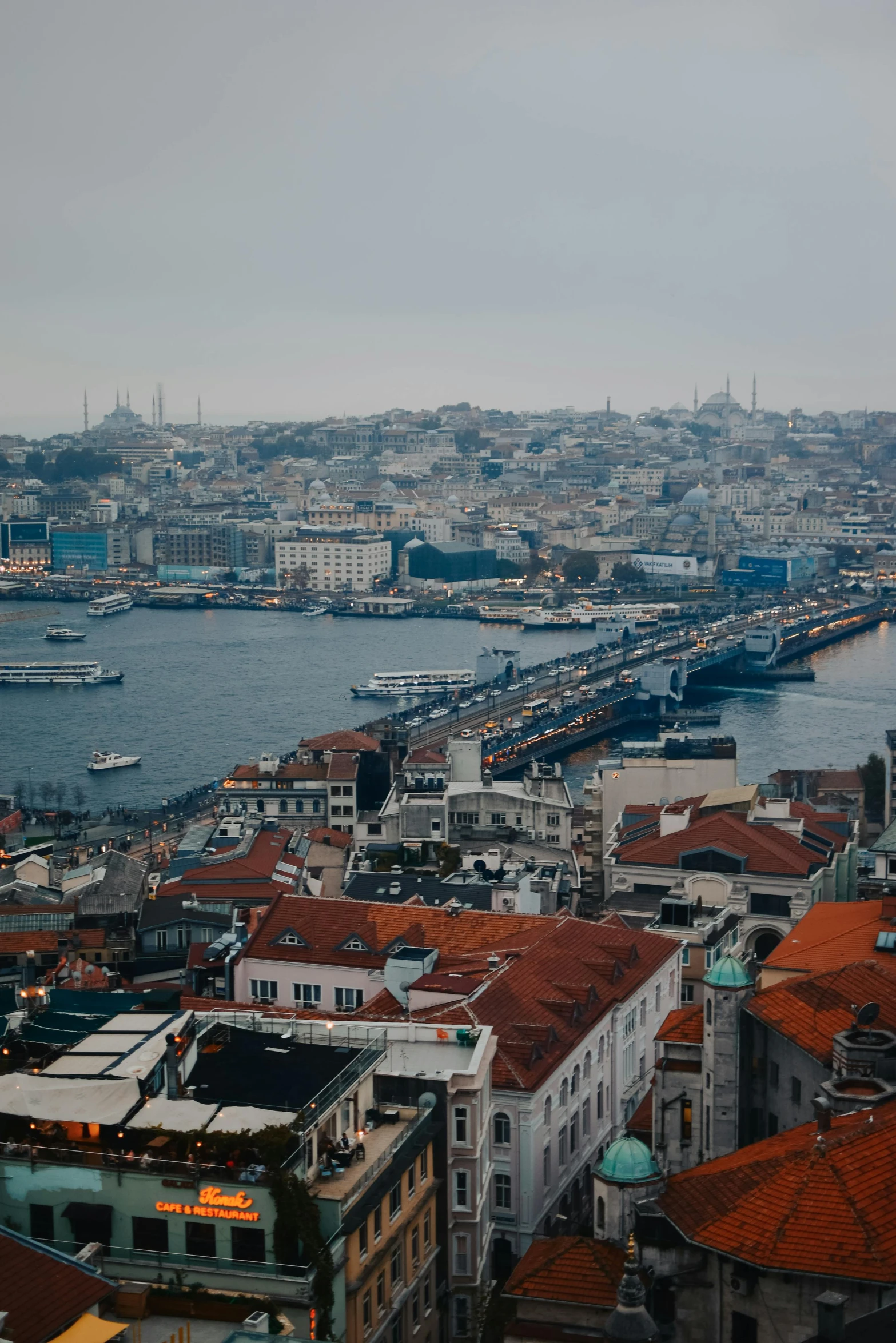 a view of a city from the top of a building, a colorized photo, pexels contest winner, hurufiyya, istanbul, slide show, grey, river in the background