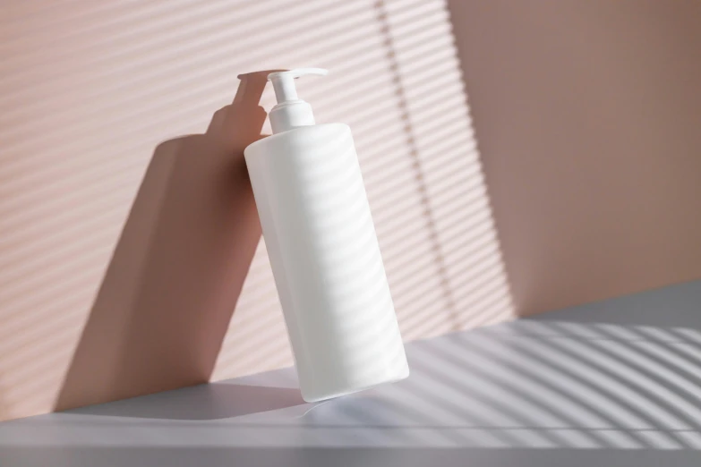 a bottle of lotion sitting on top of a counter, a 3D render, inspired by Robert Mapplethorpe, trending on pexels, long arm, sun lighting, white plastic, smooth panelling