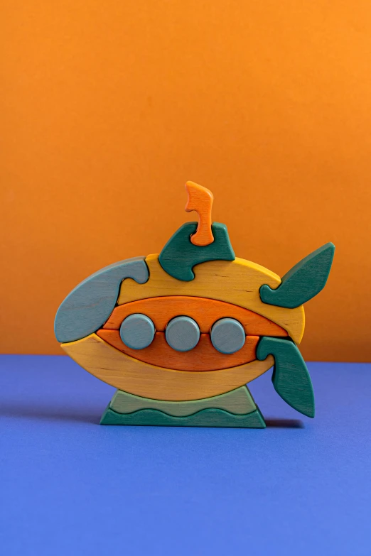 a toy submarine sitting on top of a blue surface, a jigsaw puzzle, kinetic art, chartreuse and orange and cyan, detailed product image, portrait shot, wooden