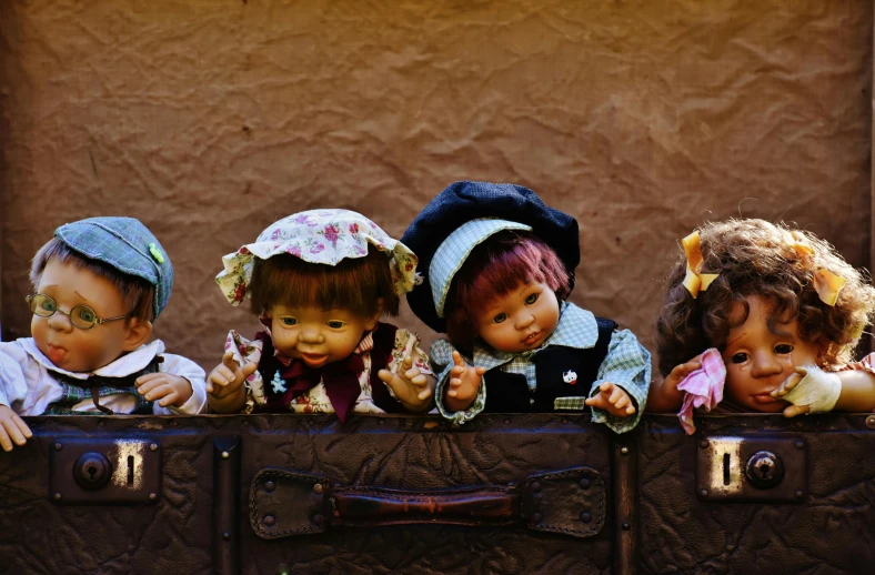 a group of dolls sitting on top of a suitcase, trending on pixabay, fantastic realism, hansel and gretel, bolivian cholitas, charming expression gesicht, lalafell