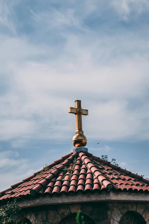 a church with a cross on top of it, trending on unsplash, tiled roofs, square, gold, 15081959 21121991 01012000 4k