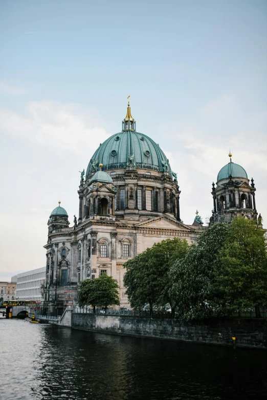 a large building next to a body of water, pexels contest winner, berlin secession, cathedral background, dome, 🚿🗝📝