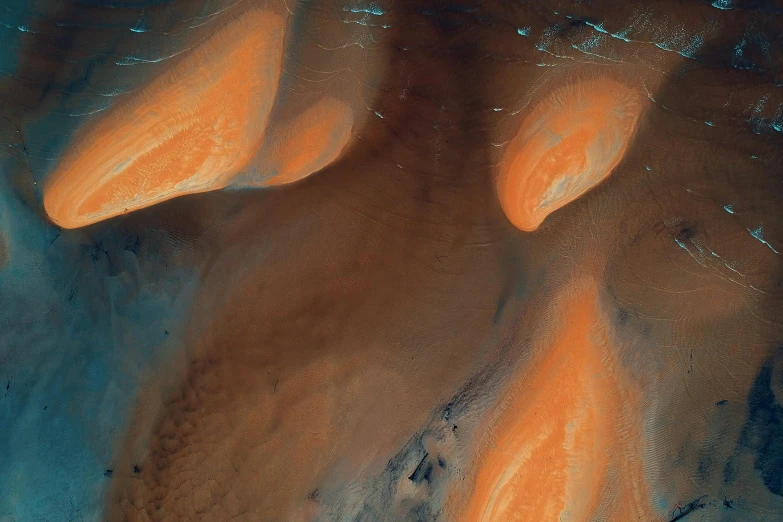 a close up of an orange substance on the surface of a body of water, an album cover, pexels contest winner, space art, victorian arcs of sand, opal, viewed from space, dune (2021)