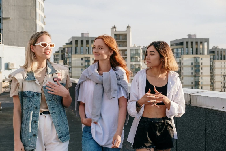 a group of women standing next to each other on a roof, trending on pexels, freckles on chicks, modern casual clothing, profile image, pokimane