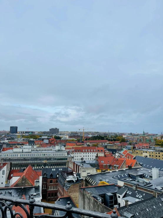 a view of a city from the top of a building, julia hetta, slight overcast weather, low quality photo, square