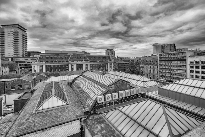 a black and white photo of a train station, inspired by Thomas Struth, pixabay, brutalism, skyline view from a rooftop, wide angle shot 4 k hdr, glasgow, a wide open courtyard in an epic