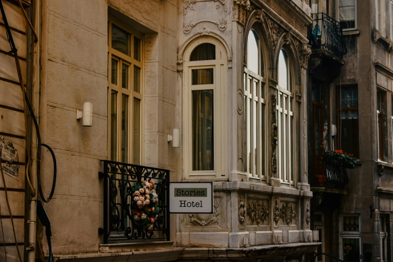 a couple of buildings that are next to each other, a photo, pexels contest winner, art nouveau, hotel room, thumbnail, entrance, brown