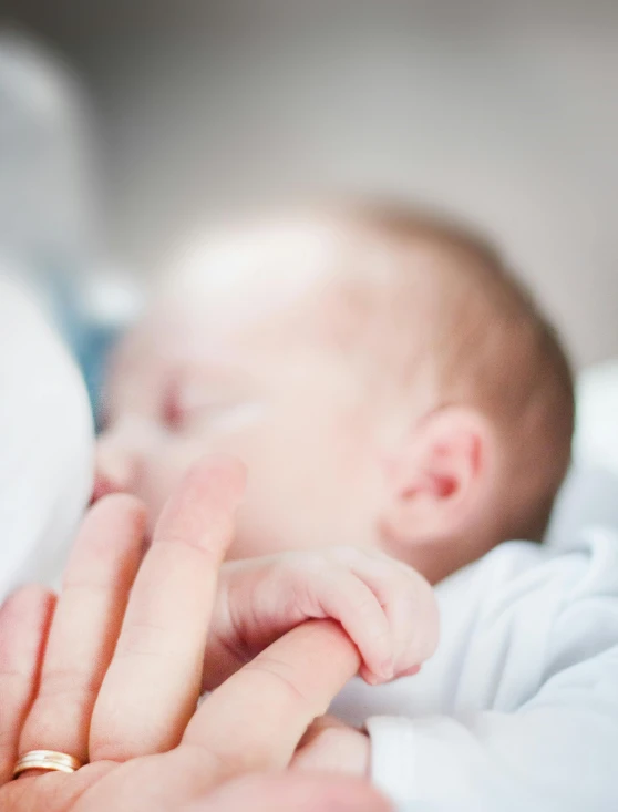 a close up of a person holding a baby, with index finger, passed out, profile image, taken in 2 0 2 0