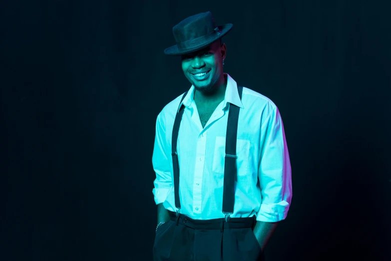 a man in a white shirt and black suspenders, an album cover, inspired by Leonard Daniels, pexels, blue fedora, posing in dramatic lighting, while smiling for a photograph, black man