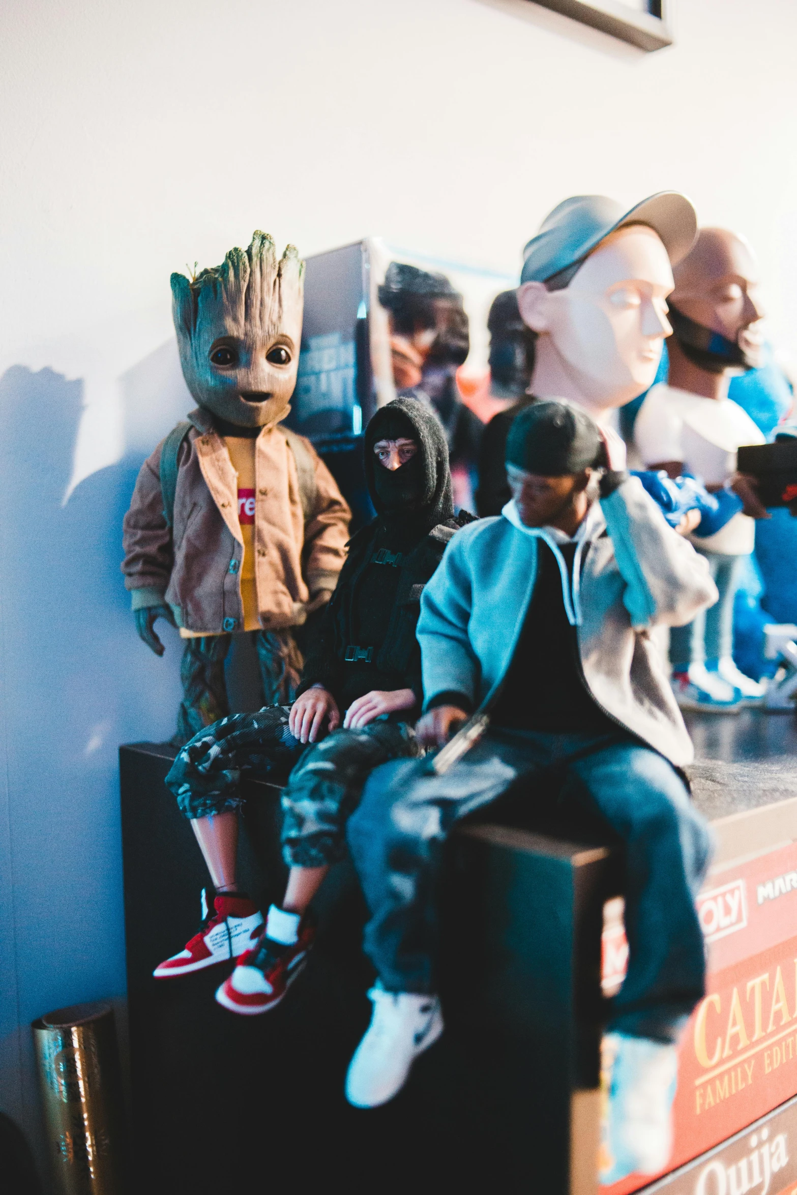 a bunch of action figures sitting on top of a table, trending on unsplash, visual art, hip hop aesthetic, groot costume, outlive streetwear collection, looking away from camera