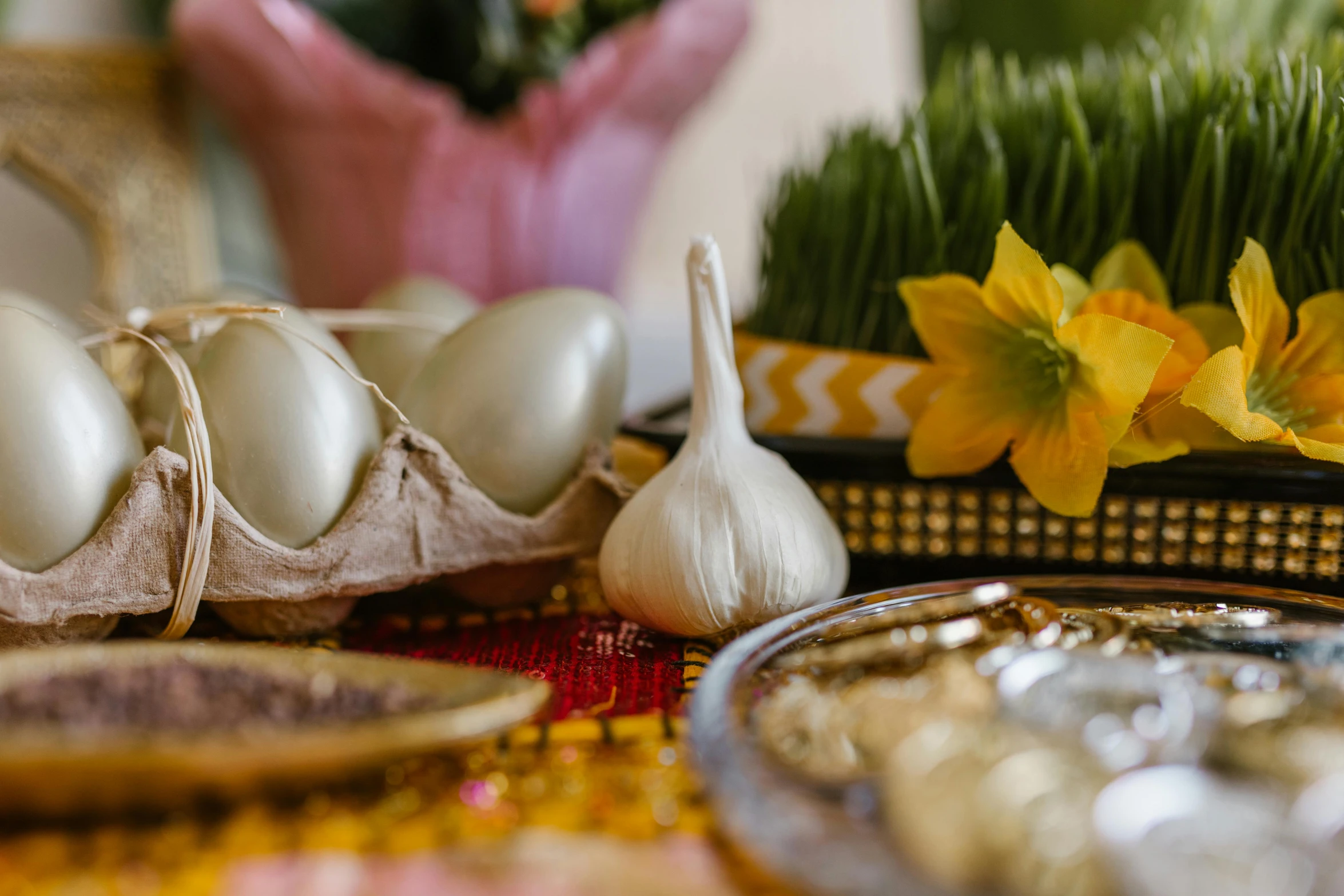 a bunch of eggs sitting on top of a table, by Aya Goda, trending on unsplash, qajar art, garlic on background, hair ornaments, displayed on an altar, yellow