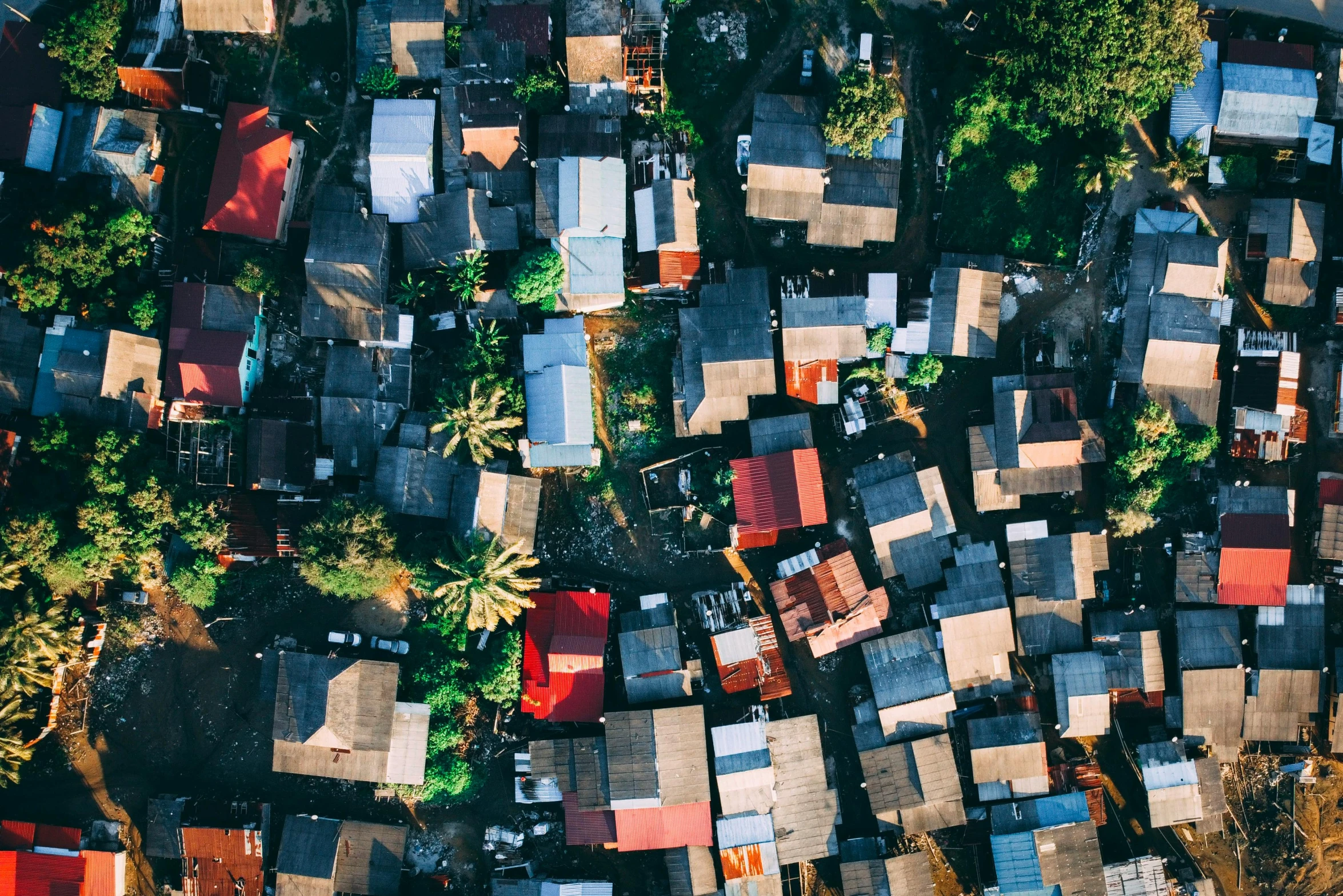 a group of houses sitting next to each other, pexels contest winner, philippines, looking down on the camera, lots of light, detailed and complex