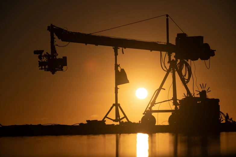 a crane sitting on top of a body of water, by Matthias Stom, pexels contest winner, hurufiyya, cinematic industrial lighting, silhouetted, avatar image, solar eclipse in iceland
