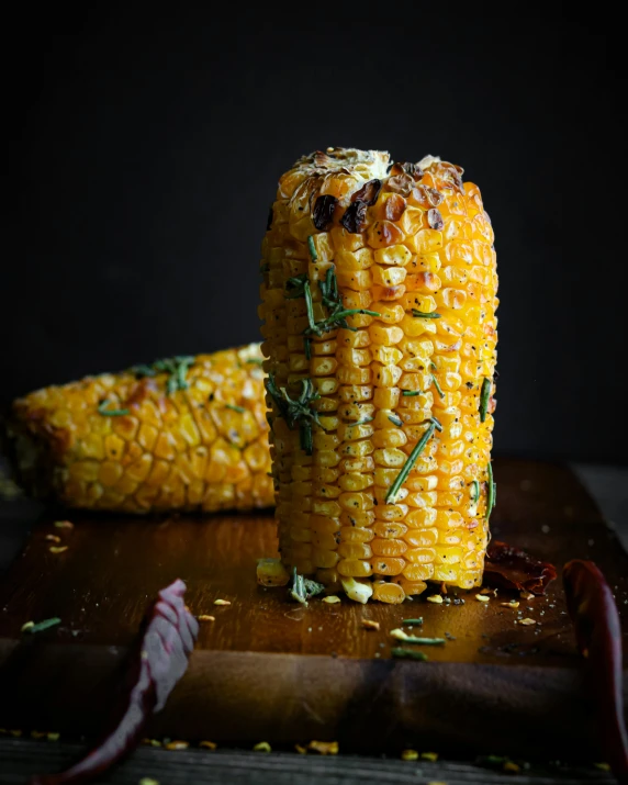 grilled corn on the cob on a cutting board, a portrait, unsplash, renaissance, thumbnail, taken with sony alpha 9, made of glazed, high quality product image”