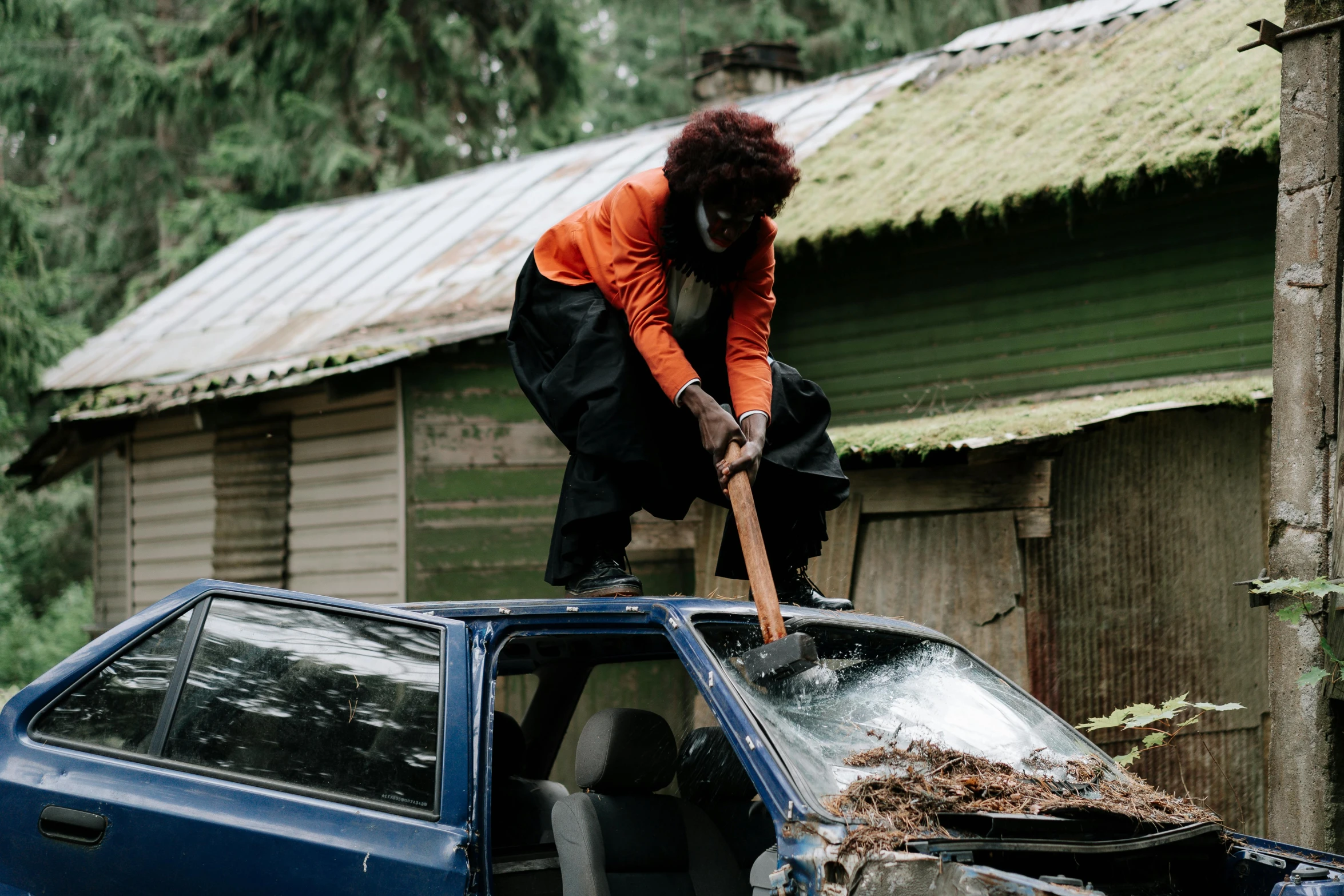 a man that is standing on top of a car, by Edwin Georgi, pexels contest winner, auto-destructive art, wielding an axe, surburb woman, annie leibowitz, pulling weeds out frantically