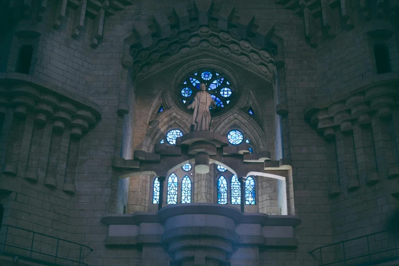 a very tall building with a clock on it's side, a statue, by Gaudi, unsplash contest winner, romanesque, gothic interior, lit windows, 4 k cinematic photo, altar